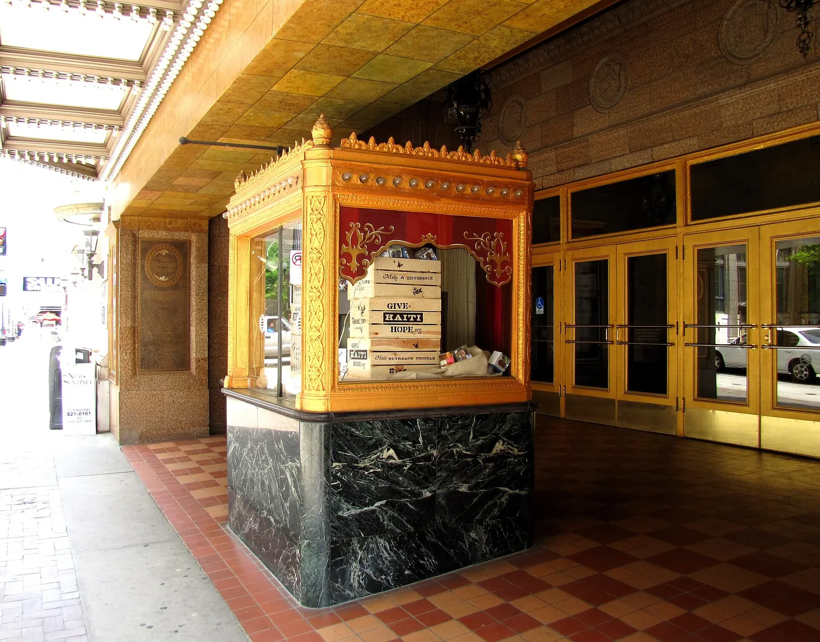 The gilded ticket booth and brass doors under the marquee of the Tennessee Theatre on South Gay Street.