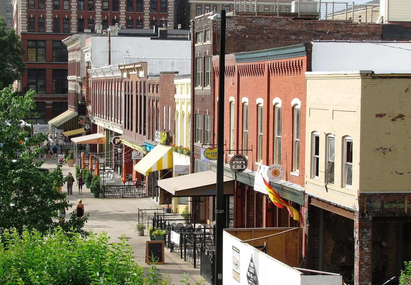 Shops, patios and 19th-century brick storefronts along the west side of Market Square in downtown Knoxville.