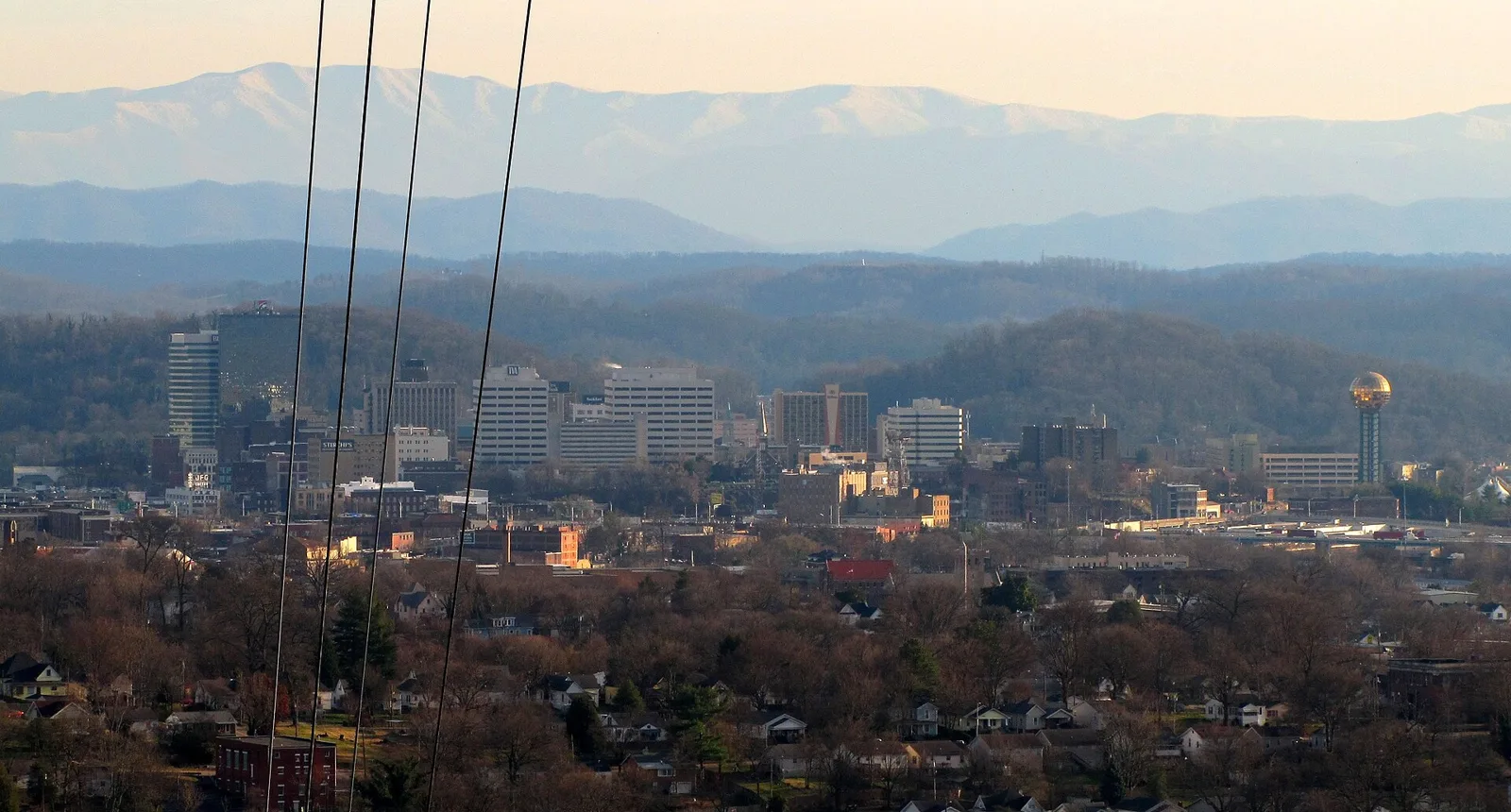 Knoxville's neighborhoods and downtown seen from Sharp's Ridge, with the Great Smoky Mountains beyond.