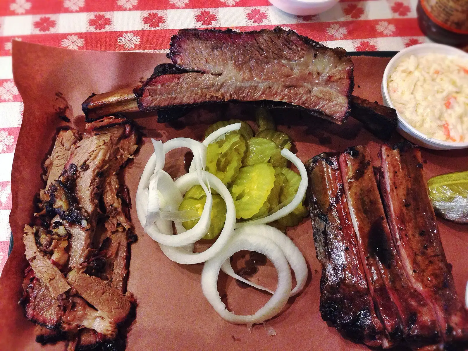 Brisket, beef rib and pork ribs on butcher paper at a Texas barbecue restaurant. The photo was not taken in Knoxville.