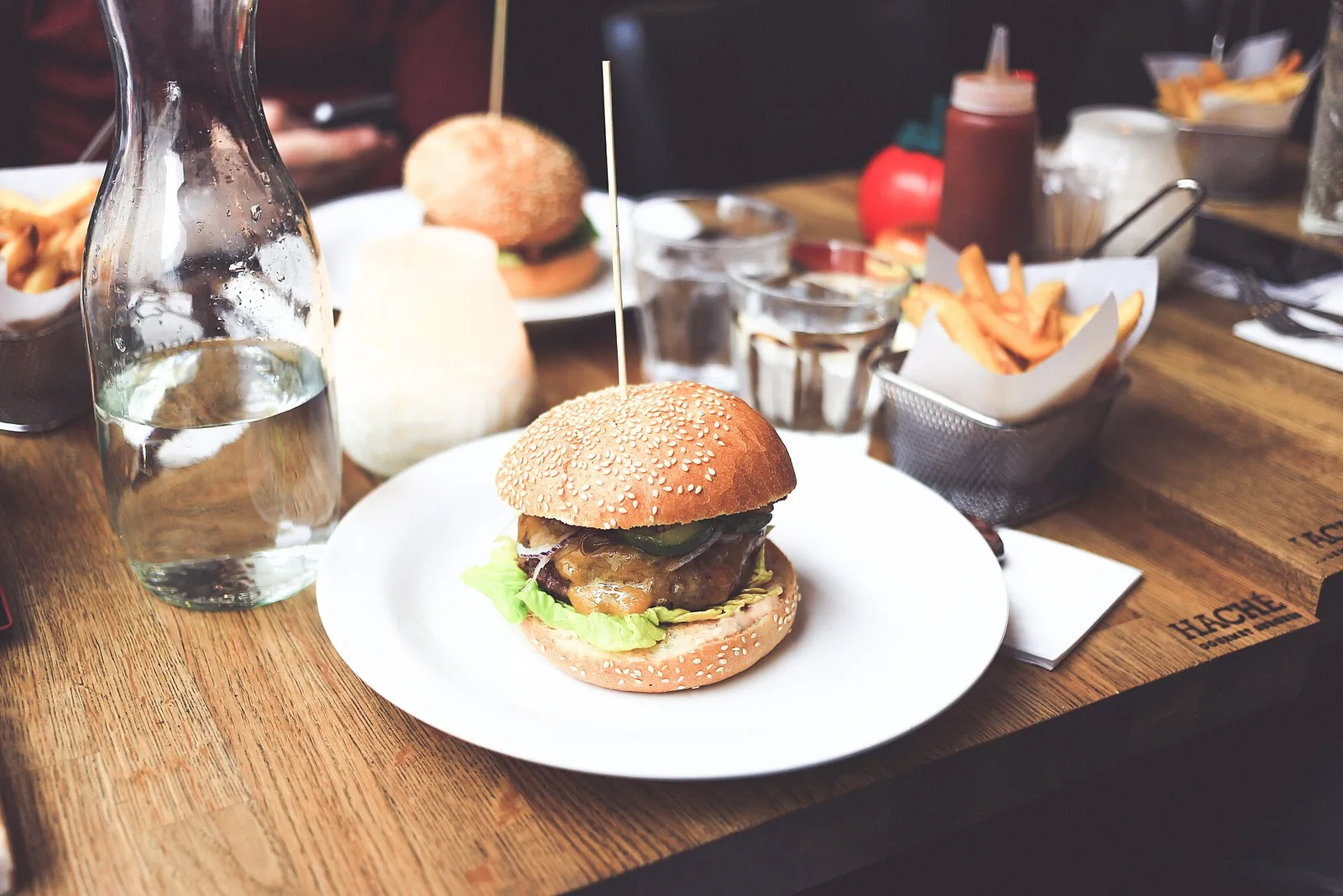 A cheeseburger with fries on a restaurant table. The photo was not taken in Knoxville.