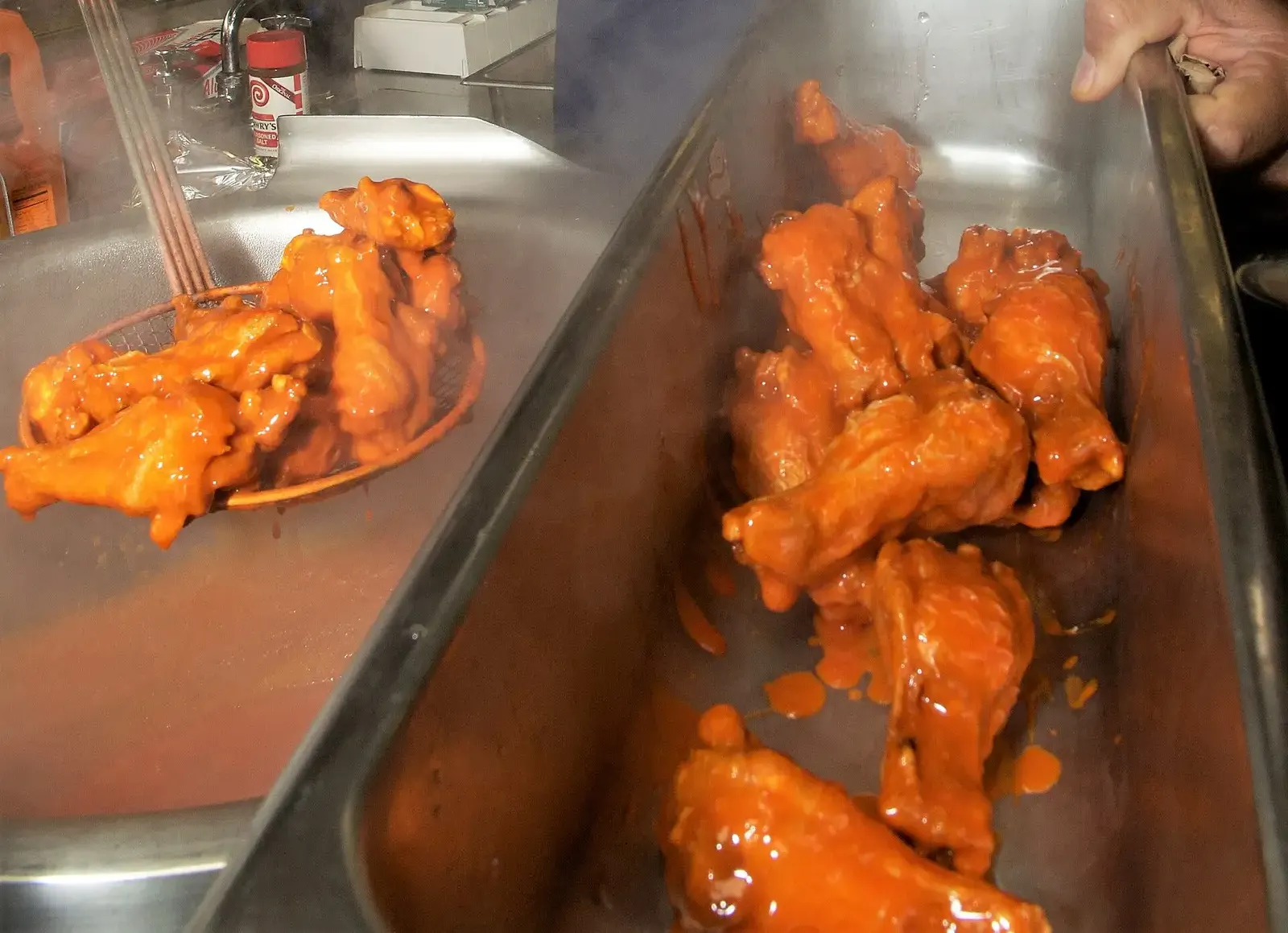 Buffalo wings coming out of the fryer in a ship's galley. The photo was not taken at a Knoxville restaurant.